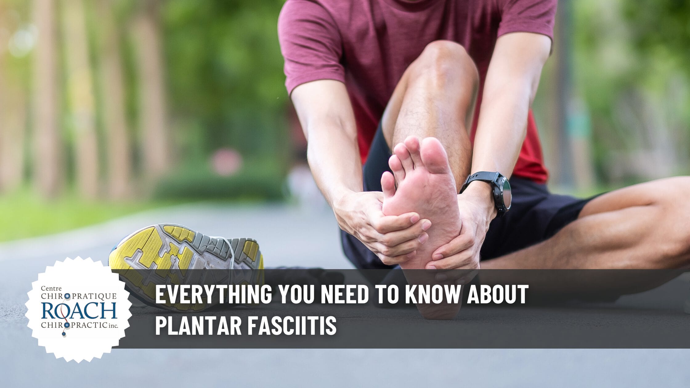 a person sitting in the street after running, shoe off and rubbing their bare foot to relieve plantar fasciitis