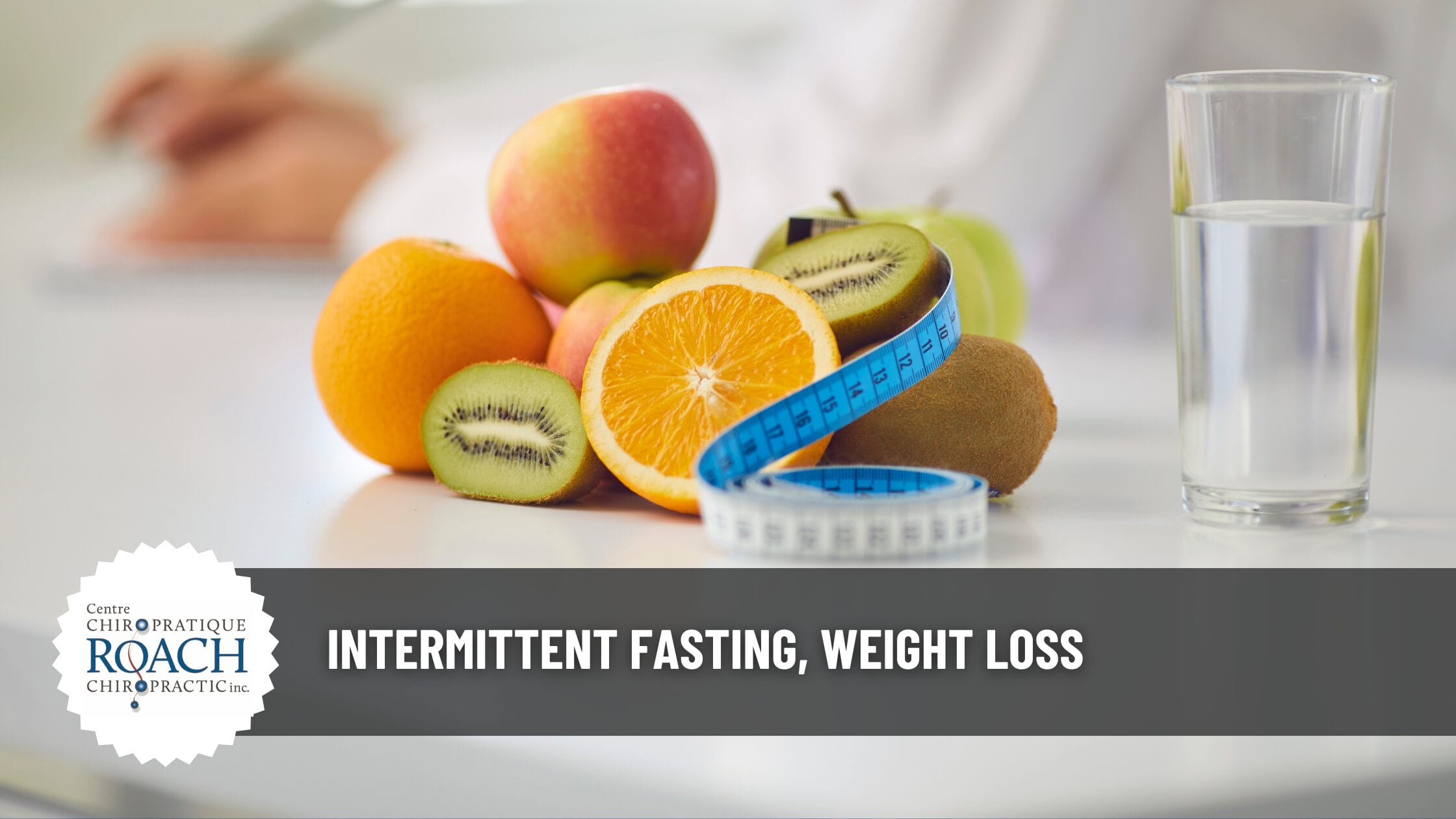 various fruits alongside a measuring tape and a glass of water