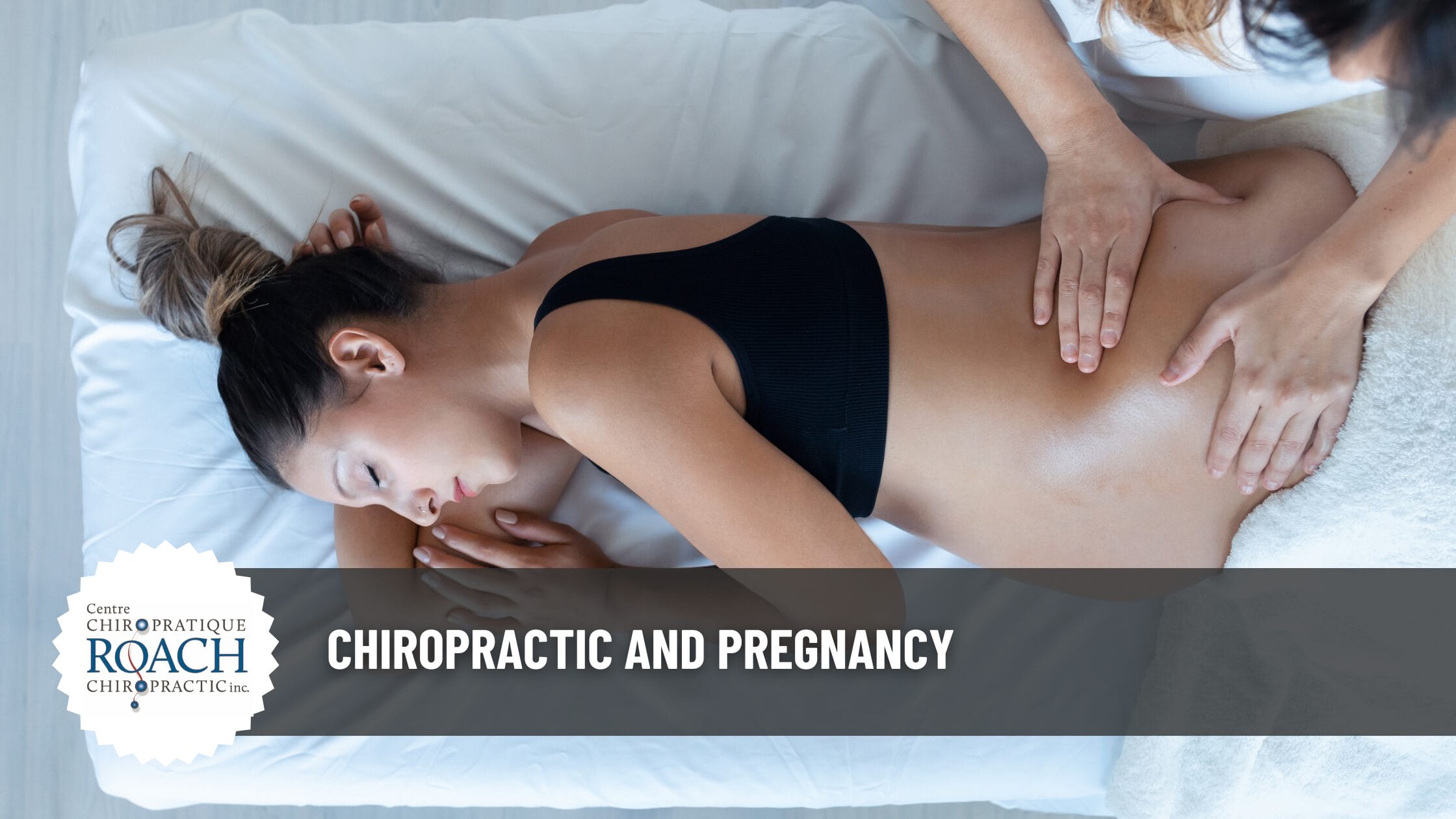 a pregnant woman lying on a table receiving chiropractic care