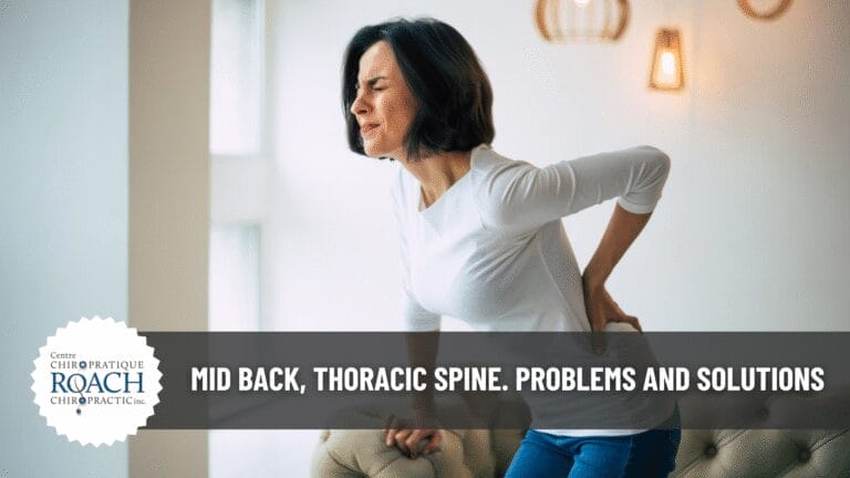 a woman holding her back experiencing mid back, thoracic spine pain.