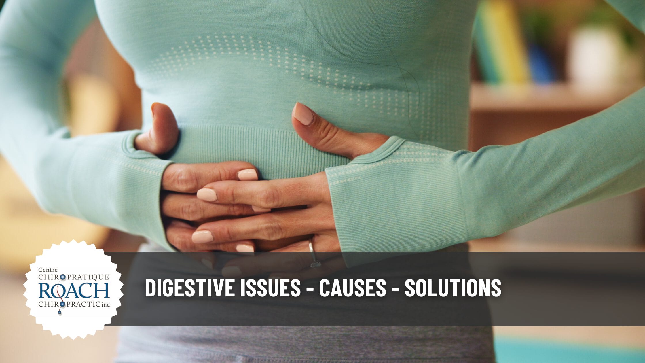 a woman holding her stomach area in pain experiencing digestive issues