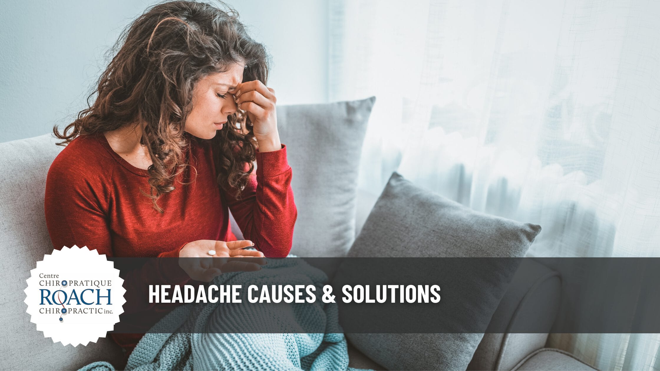 a woman sitting on a couch pinching her forehead in pain with a headache