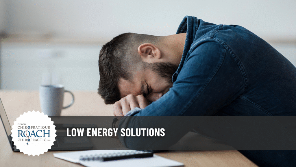 Low Energy Solutions 4 a man sitting in a chair, resting on the desk in front of him due to fatigue