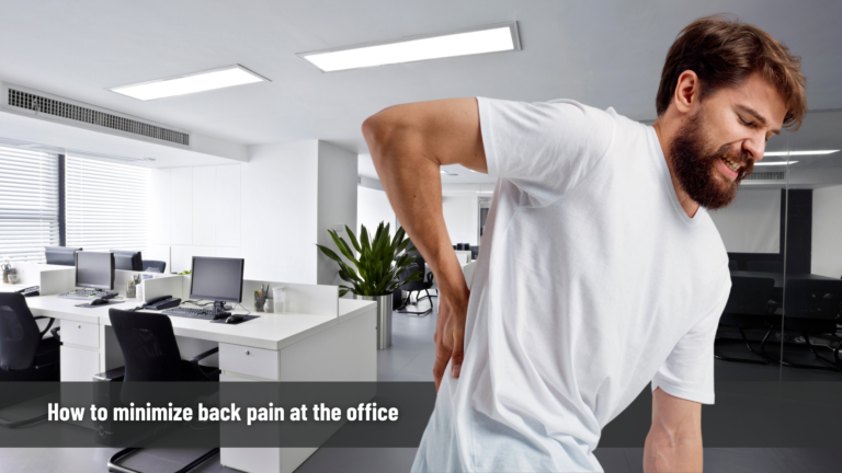 a man in a white shirt with back pain at the office