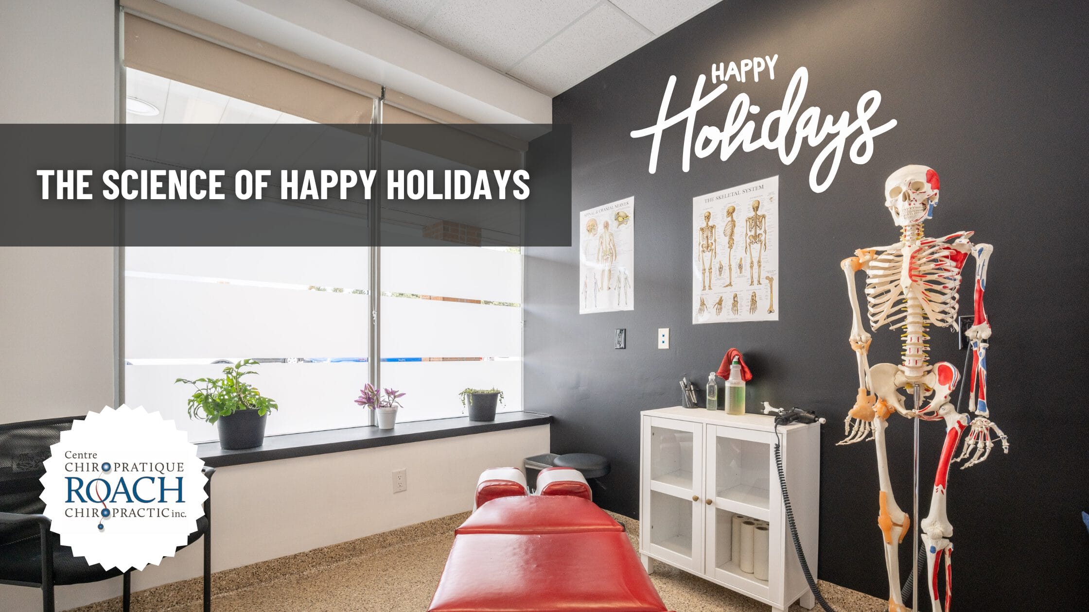 a chiropractic room with happy holidays written on the wall