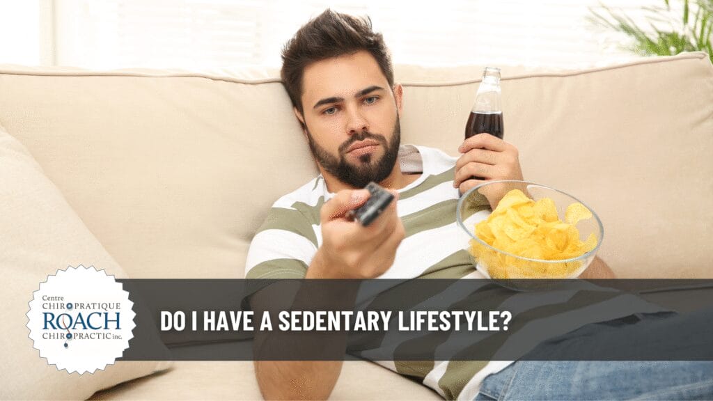 a person lounging on a couch with a bowl of chips resting on his chest, a bottle of soda pop in hand, and a tv remote in the other hand.