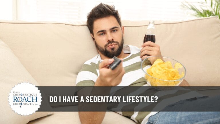 a person lounging on a couch with a bowl of chips resting on his chest, a bottle of soda pop in hand, and a tv remote in the other hand.