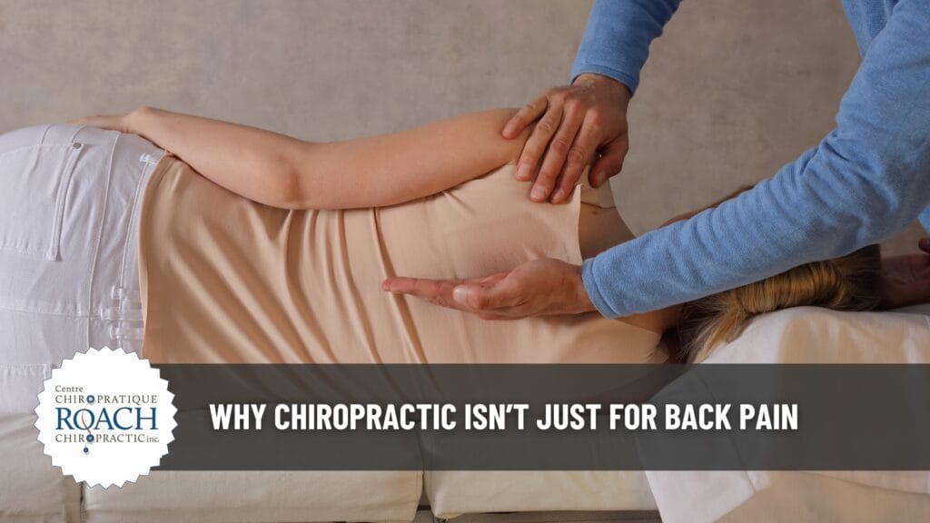 Chiropractor adjusting patient's spine and gently indicating the proper adjustment area.
