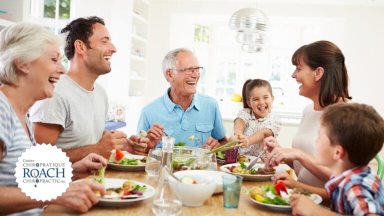 a generational family sitting around the dinner table discussing chiropractic care, health & wellness for everybody