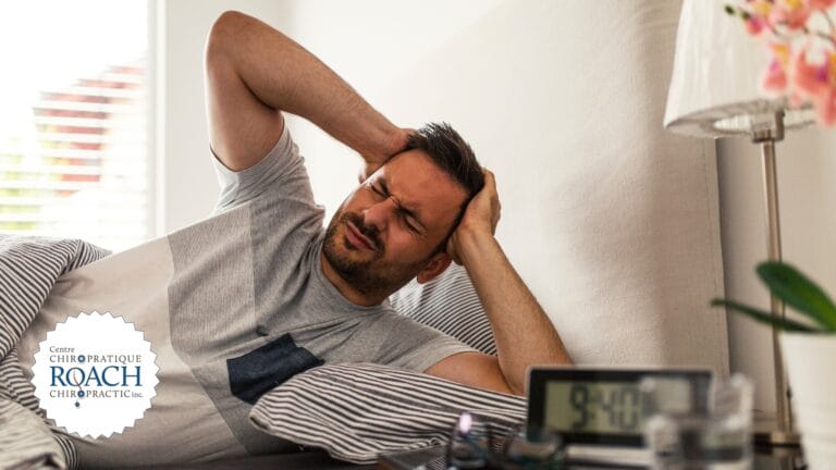 a man in bed unable to sleep due to a headache